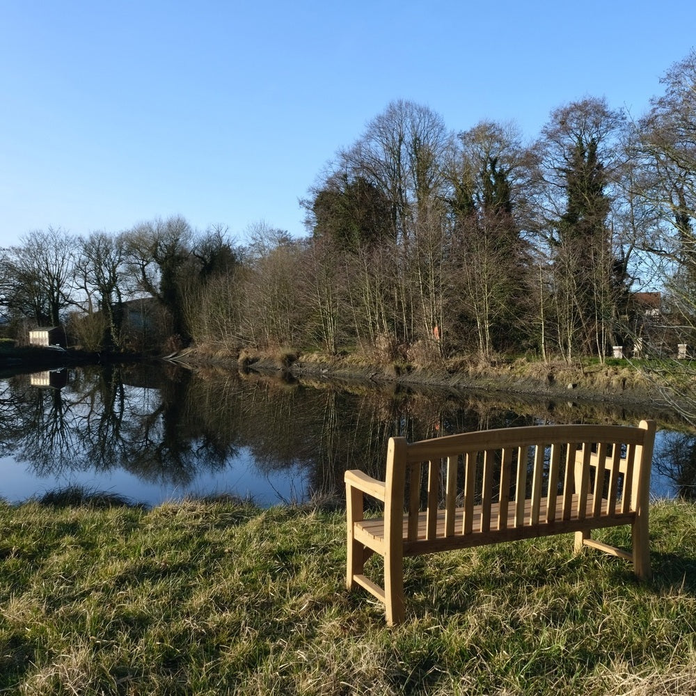 Image of a reservoir at David Austin with a bench over looking the water