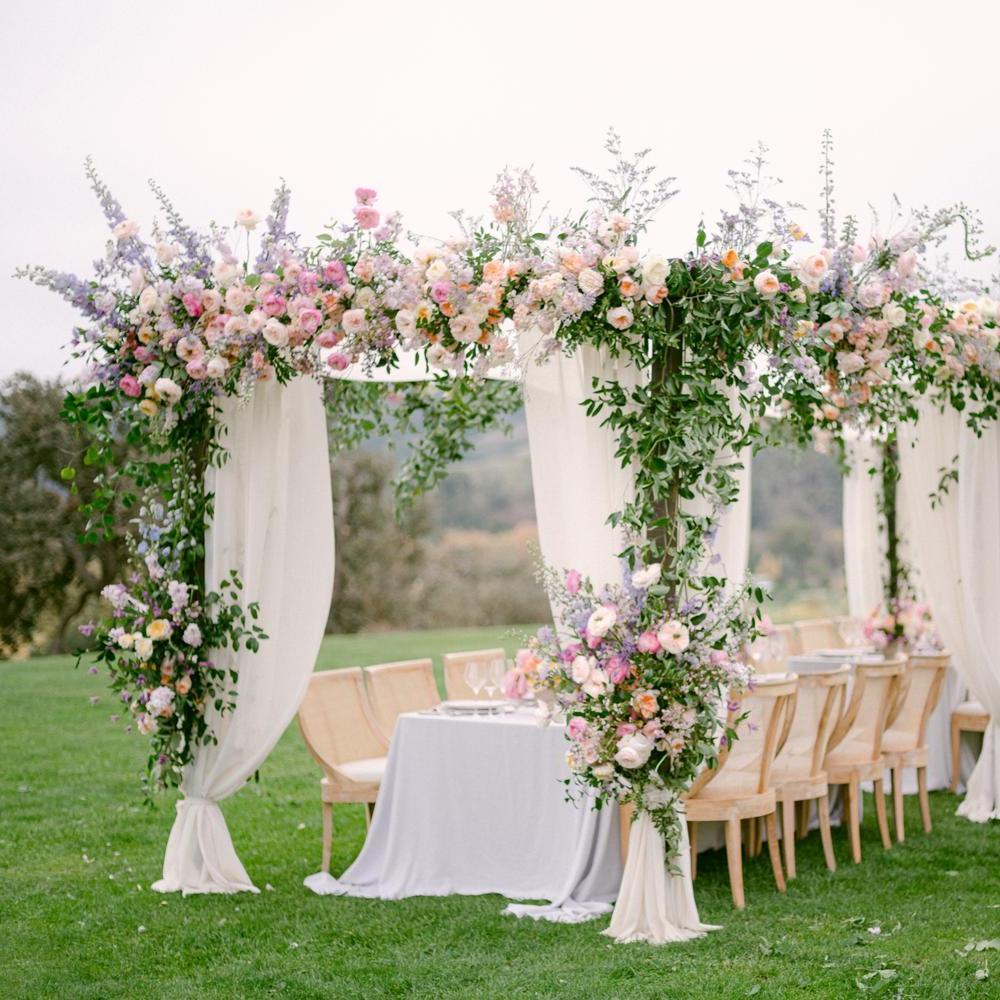 A display of David Austin wedding roses on a  outdoors structure